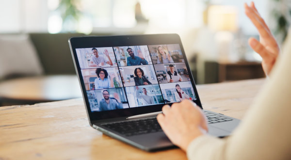 Laptop showing a live webinar with multiple participants on screen